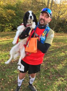 Photograph of client holding up his dog